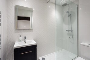 Shower, rainfall showerhead, hair dryer, towels