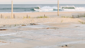 A beach with a wooden fence and two vertical posts, leading to the ocean. - Romantic Queen Suite 1 Block to Beach & Asbury | Victorian Charm | 1000 Mbps ... (Neptune Township)