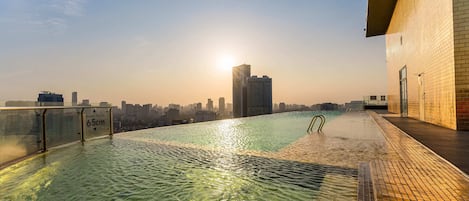 Outdoor pool, open 6:00 AM to 10:00 PM, pool umbrellas, pool loungers