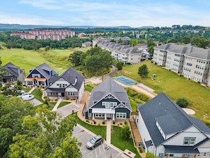 A residential area with houses, a tennis court, and a golf course.