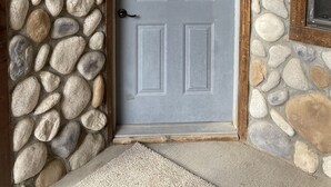 A stone wall with a gray door featuring a semi-circular window above it. - On the Rio Grande. Direct ATV Access from the property to National Forest Roads. (South Fork)
