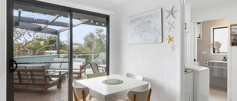 A modern kitchen with white cabinets, a built-in oven, and a countertop.