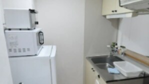 A compact kitchen with white appliances, a sink, and a countertop. - IKminami6jo residence 101 (Sapporo)
