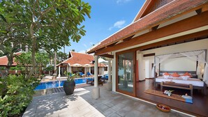 A hotel room with a large bed, a private balcony with a pool, and a view of other hotel rooms. - Baan Chao Lay (Koh Samui)