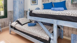A bunk bed with a floral-patterned bedspread and blue pillows. - Coto Gamo Holiday Escape by Interhome (Pals)