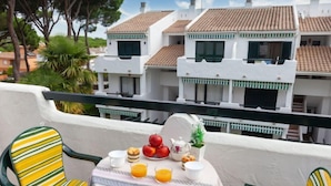 A balcony with a table set for breakfast, chairs, and a view of terracotta-roofed buildings. - Coto Gamo Holiday Escape by Interhome (Pals)