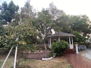 Stroll through the serene garden, surrounded by lush trees and vibrant flowers, and relax in the tranquil gazebo.