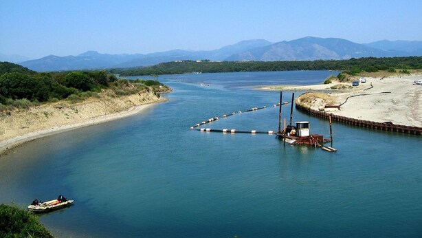 A river with a boat dock, a small boat, and a bridge. - Charming villa for 4 people, private pool between sea and mountains  (Aléria)