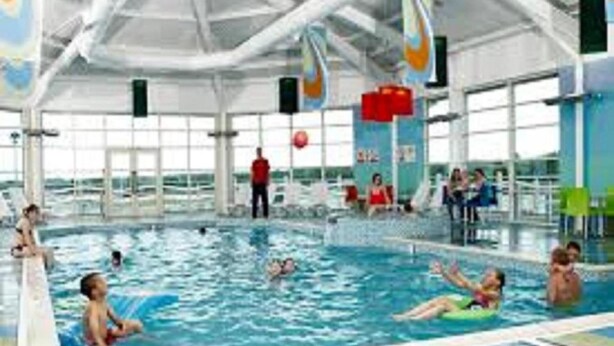 An indoor swimming pool with multiple lanes, lifeguard stands, and a clear roof structure. - Immaculate 3-bed Caravan in Hartlepool (Hartlepool)