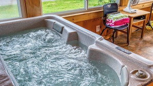 A hot tub with a wooden interior, a chair with towels, and a window view. - 🐾Lakeview on Main - Located in the village of Rangeley with water views! Dog Friendly (Rangeley)