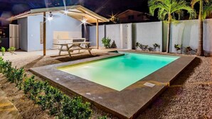 A rectangular swimming pool with a covered patio area, a table, and chairs. - ★ Flat 1 - Modern 2 BR 2 Bath - 300m from beach ★ (Playas del Coco)