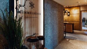 Interior moderno de un spa con una pared de madera que muestra el nombre 'HIMMELREICH PANORAMASPA'.