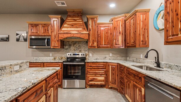 A kitchen with wooden cabinets, a stainless steel oven, a microwave, and granite countertops. - 2Kings 7Queens 2Twins 2Fulls - Pool Table - Near BoatRamp&Beach (Kingston)