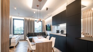 Une cuisine moderne avec un coin repas, un canapé et une vue sur la ville.