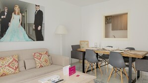 A modern living room with a sofa, a coffee table, and a dining area with a table and chairs. - Pompidou 20 - 2 Rooms (Málaga)