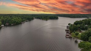Ein Fluss mit Häusern am Ufer, umgeben von Bäumen.