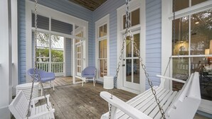 A porch with white swing chairs and a white bench, connected by chains. - Gulf Views from Tower in Seaside, 6 Houses to Private Beach & 2 Adult Bikes! (Santa Rosa Beach)