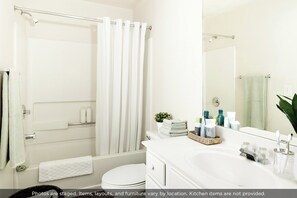 Combined shower/bathtub, towels, soap, toilet paper