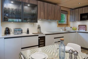 Une cuisine moderne équipée d’un four à micro-ondes encastré, d’un grille-pain et d’un bloc à couteaux.