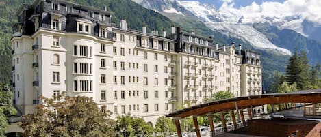 A multi-story hotel with a classic European architectural style, featuring a symmetrical facade with evenly spaced windows and balconies.