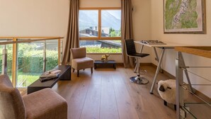 A modern room with a large window, a wooden ceiling, a map on the wall, and a desk with a chair. - Chalet Couttet -  a self catered chalet that sleeps 8 guests  in 4 bedrooms (Chamonix)