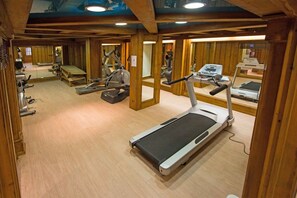 A gym with treadmills, stationary bikes, and other fitness equipment.