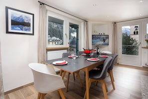 Dining table with view out the large windows - Panoramic Mont Blanc apt Skiing, Chamonix All Year (Chamonix)