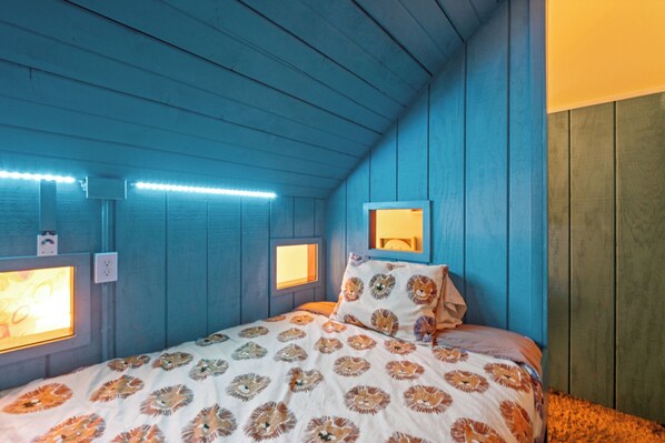 A bedroom with a blue ceiling, a bed with a lion print bedspread, and two wall-mounted light fixtures. - Lakefront Escape w/ Boathouse & Helipad – Your Ultimate Lake Gaston Getaway (Littleton)