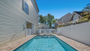 A rectangular swimming pool with clear blue water, surrounded by a brick patio and white fences. - 1 Precious Memory - 4 Bed/3 Bath - Private Pool (North Myrtle Beach)