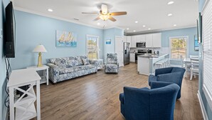 A spacious living area with a sofa, chairs, a TV, and a ceiling fan. - 1 Precious Memory - 4 Bed/3 Bath - Private Pool (North Myrtle Beach)