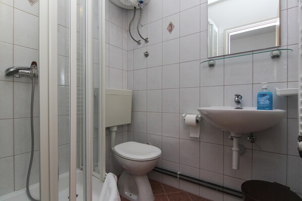 A bathroom with a shower, toilet, sink, and mirror. - VILLA ALEX One-Bedroom Apartment (LUKA) (Podaca)