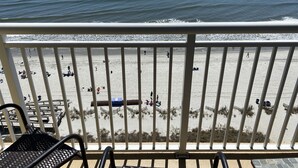 Un balcon avec vue sur la plage et l’océan.