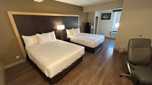 A hotel room with two beds, a desk, a chair, a TV, and a picture on the wall. - Econo Lodge Sudbury (Sudbury)