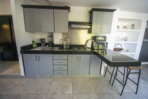 Fridge, microwave, stovetop, coffee/tea maker