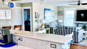 A kitchen with granite countertops, a coffee maker, and a clock on the wall. - 484 E Market - New construction close to town and the Beach! (Lewes)