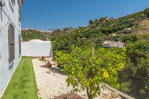Enjoy a serene hillside retreat with a beautifully maintained garden and scenic views of the surrounding landscape.