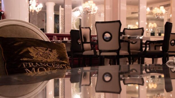 A luxurious hotel lobby with a reflective floor, elegant chairs, and a decorative item with "FRANSESCO" visible. - Villa Palma Boutique Hotel (Panama City)