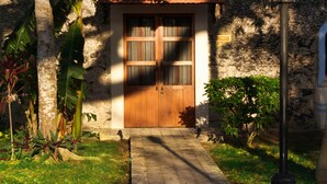 A stone building with a wooden door, a paved pathway, and a street lamp. - Full Hacienda Santuario Noc Ac (Mérida)
