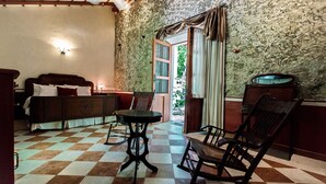 A room with a checkered floor, a bed, a table, and chairs. - Full Hacienda Santuario Noc Ac (Mérida)
