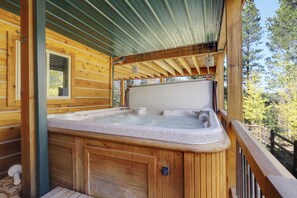 A wooden cabin with a hot tub, a window, and a metal roof. - Tranquil 4BR on Peak 7 w/ Hot Tub, Dog Friendly! (Breckenridge)