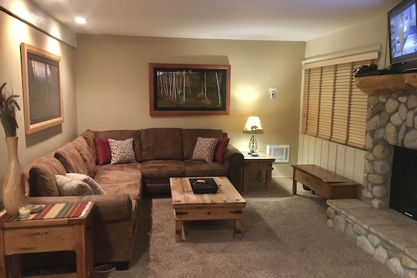 Spacious living room with Roku TV, cable TV, and gas fireplace