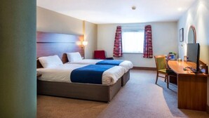 A hotel room with two beds, a desk, a chair, and a window with curtains. - Park Inn by Radisson Doncaster (Doncaster)