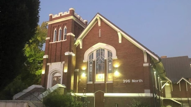 A brick building with a large arched window and a small tower-like structure on the left. The address "396 North" is visible on the building. - The "Crash Pad" Studio Apartment in Downtown Provo (Provo)