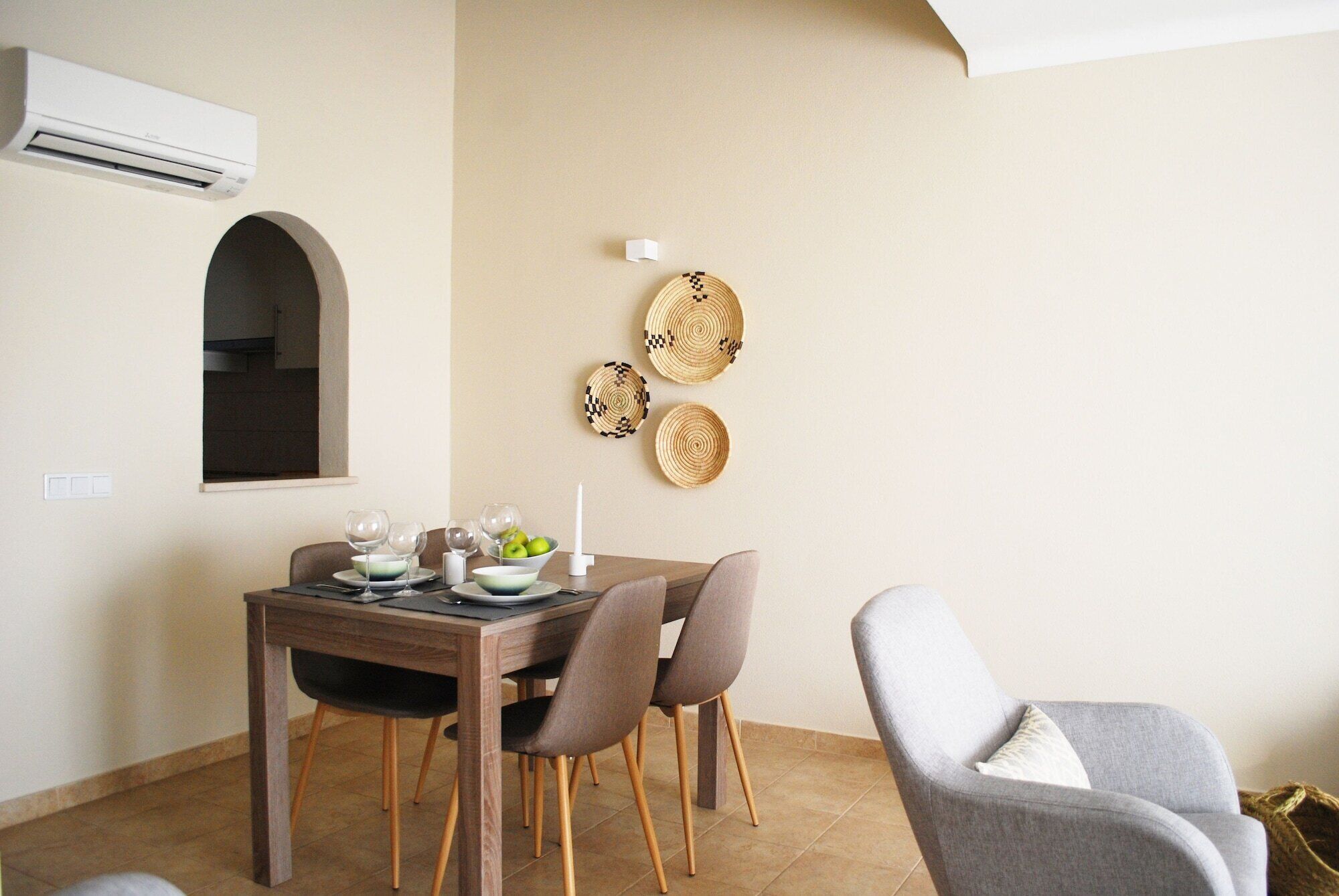 A dining area with a wooden table, four chairs, and a small window.