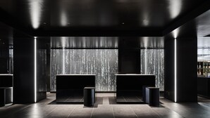A modern, dimly lit reception area with a sleek, minimalist design. - The Royal Park Canvas Kyoto Nijo (Kyoto)