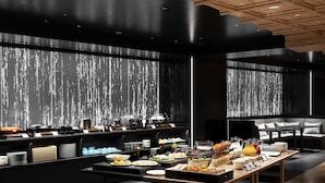 A modern breakfast buffet with a variety of food items and a seating area with a sofa and table. - The Royal Park Canvas Kyoto Nijo (Kyoto)