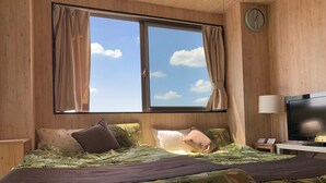 A room with a bed, a TV, a clock, and a window with curtains. - A-Style Matsu 601 (Osaka)