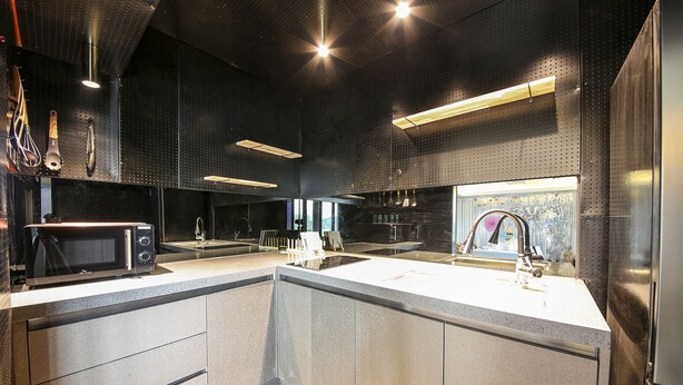 A modern kitchen with a central island, stainless steel appliances, and pendant lighting. - Diamond Hotel (Jinju)