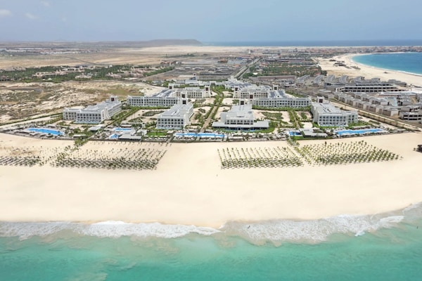 On the beach, sun loungers, beach umbrellas, windsurfing