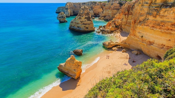 A coastal landscape with cliffs, clear turquoise waters, and a sandy beach. - A46 - Oliveira Downtown Apartment (Lagos)